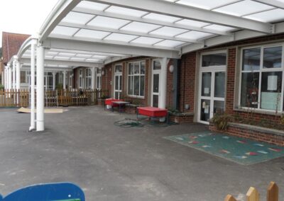 Curved canopy roof over outside play and teaching area