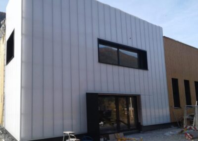 Sun Modul modular system full height opaline wall cladding incorporating doors and windows to exterior façade